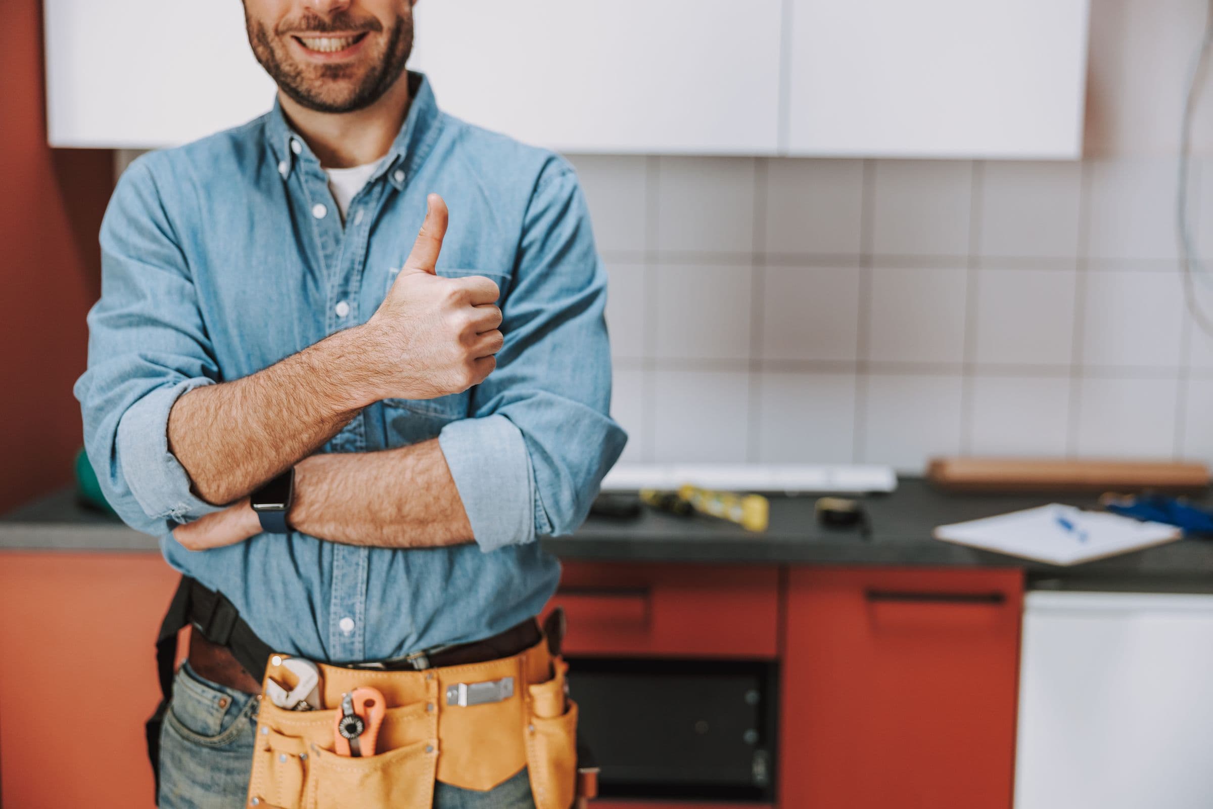 A tradesman with a tool belt at a job
