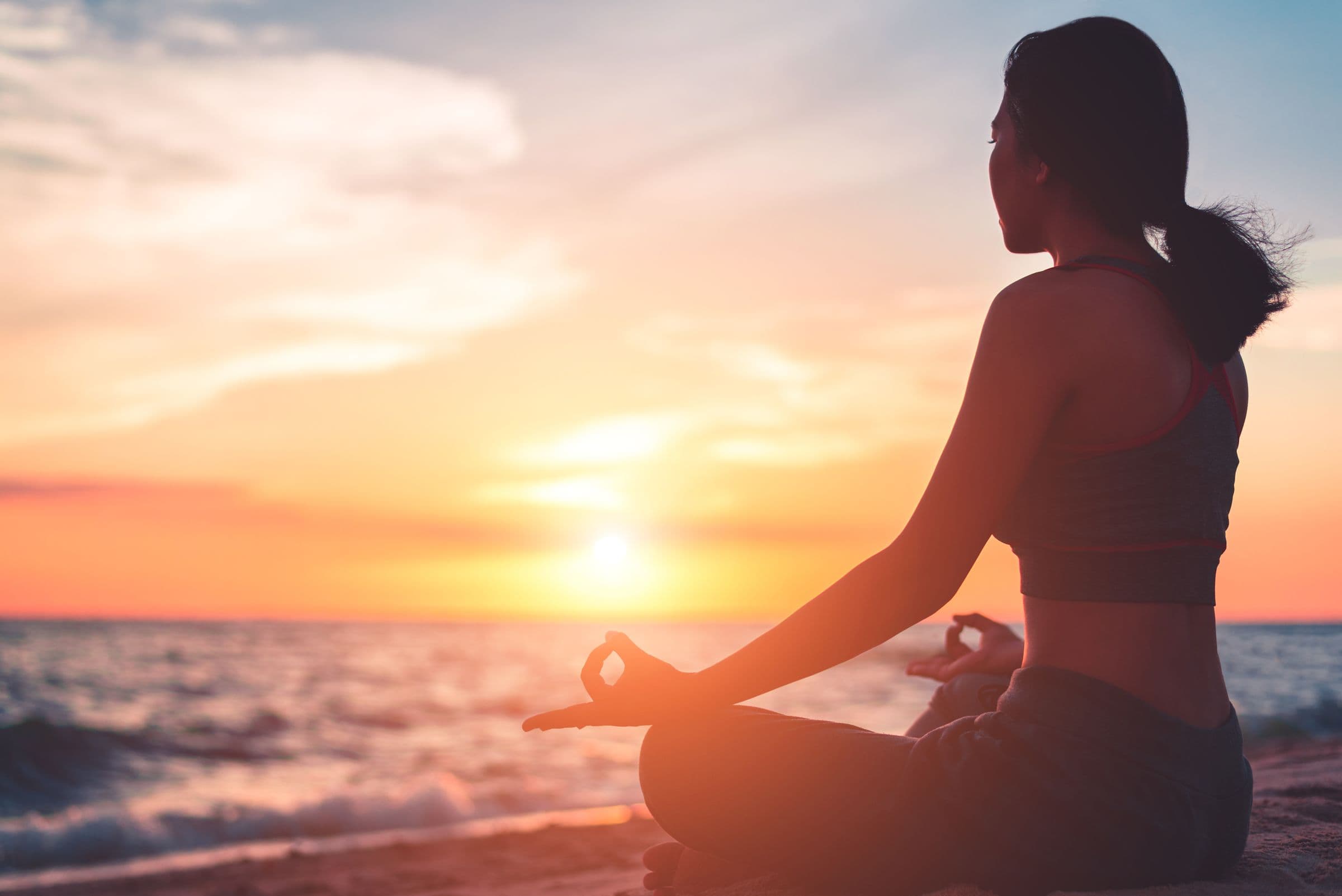 Yoga on the beach at sunset