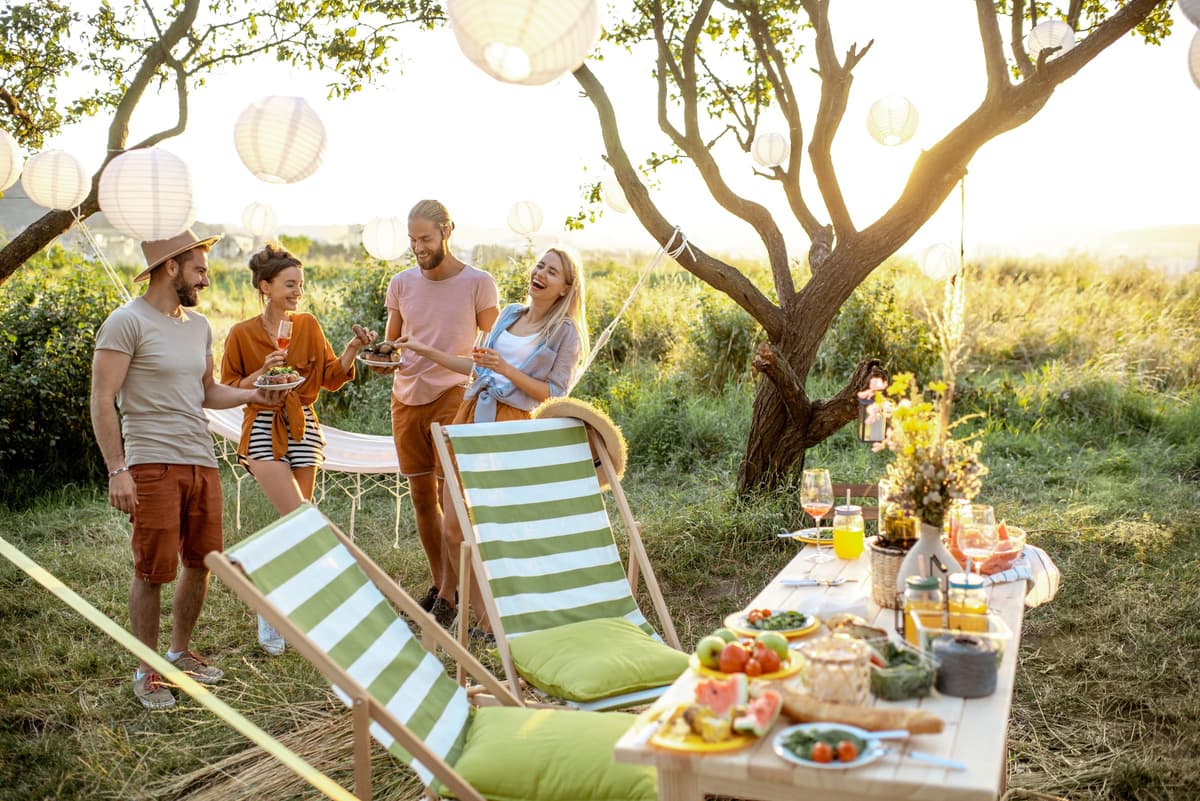 Friends gathered around a garden table at golden hour