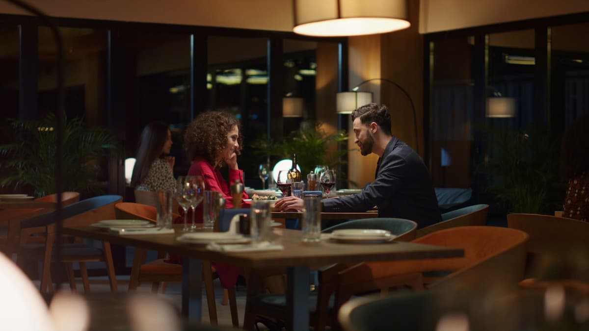 A couple enjoying dinner together at an Algarve restaurant in the evening