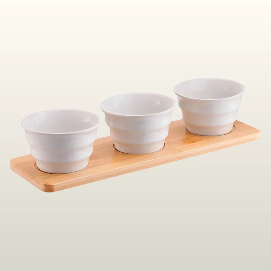 Set of 3 ceramic appetiser bowls on a bamboo tray, white